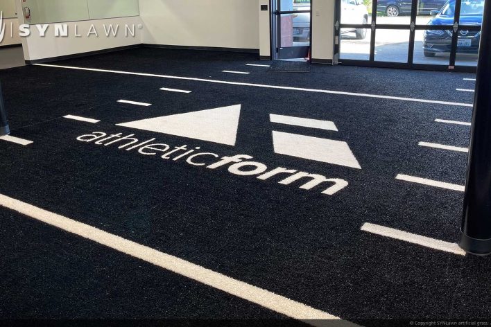 SYNLawn Nebraska prefab turf logos for athletic weight room applications